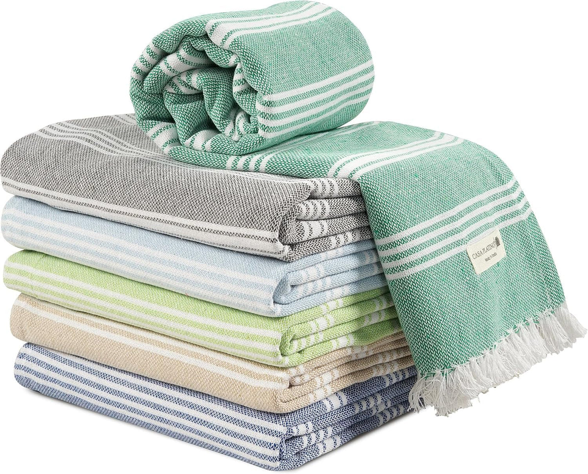 Casa Platino Turkish beach towels 6-pack spread on the sand, showcasing sand-free comfort.