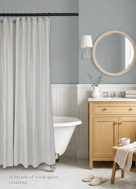 CasaTena dusty blue striped curtain enhances bathroom decor with timeless style.