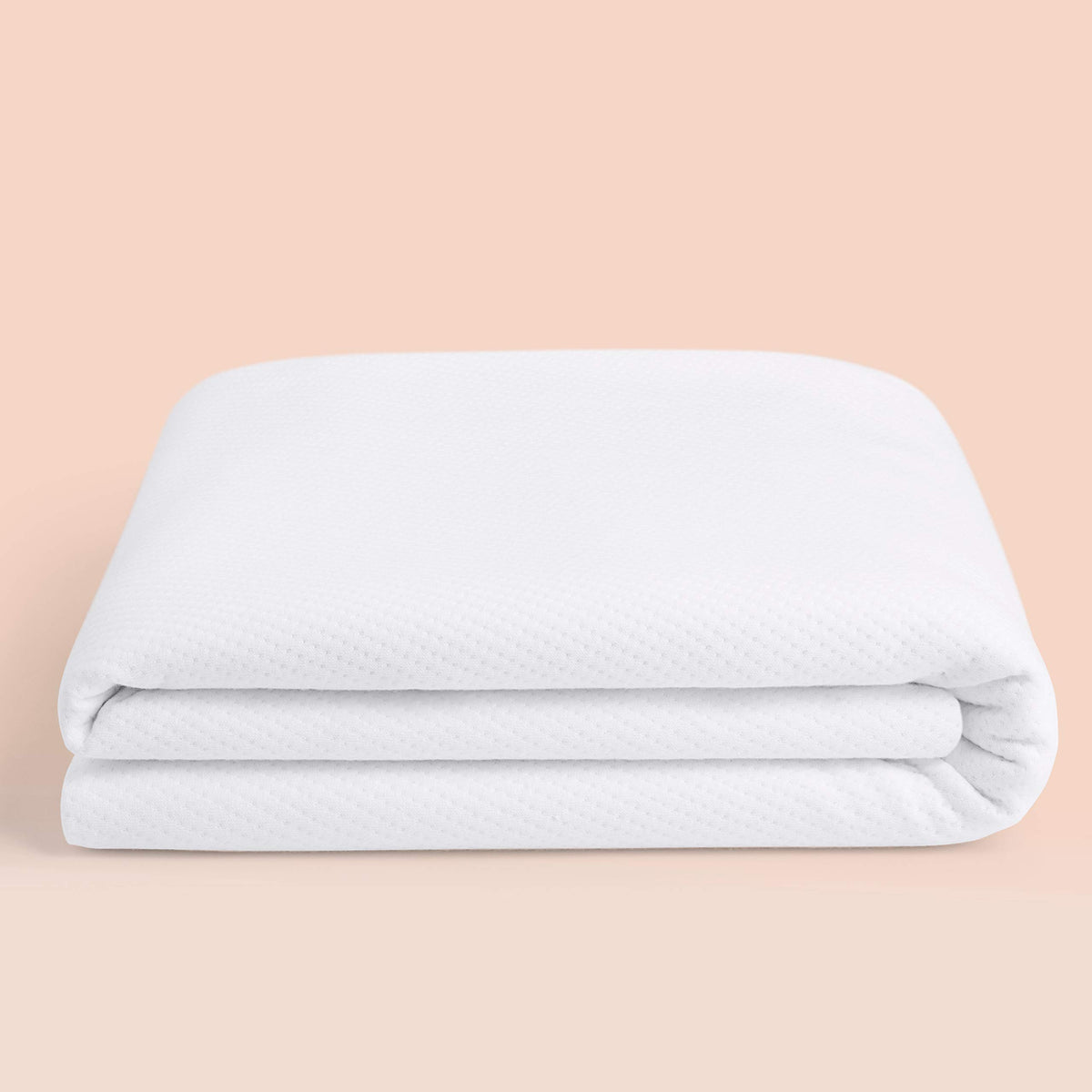 Casper Sleep Waterproof Mattress Protector on a queen bed, top view, guards against spills