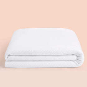 Casper Sleep Waterproof Mattress Protector on a queen bed, top view, guards against spills