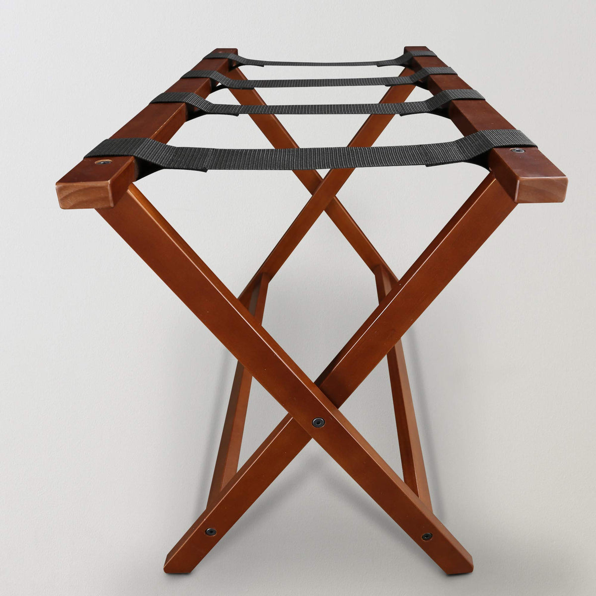 Casual Home luggage rack in a guest room scene ready for arrivals.