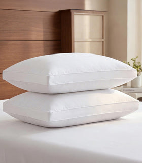 CGK Unlimited bed pillow 2-pack with soft down-alternative fill for plush comfort.
