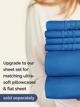 CGK Unlimited bed setup with royal blue sheet for hotel vibe.