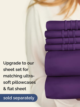 CGK Unlimited purple king bedding in a cozy bedroom scene.