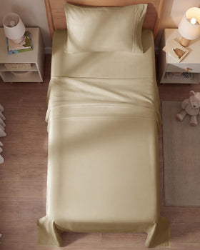 A bedroom setup with CGK Unlimited beige sheets for a hotel-inspired look.