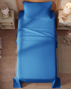 CGK Unlimited bedroom setup with royal blue sheets for a hotel-grade vibe