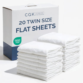CGK Unlimited twin flat sheet bulk pack on bed showing neat hotel-style top sheet