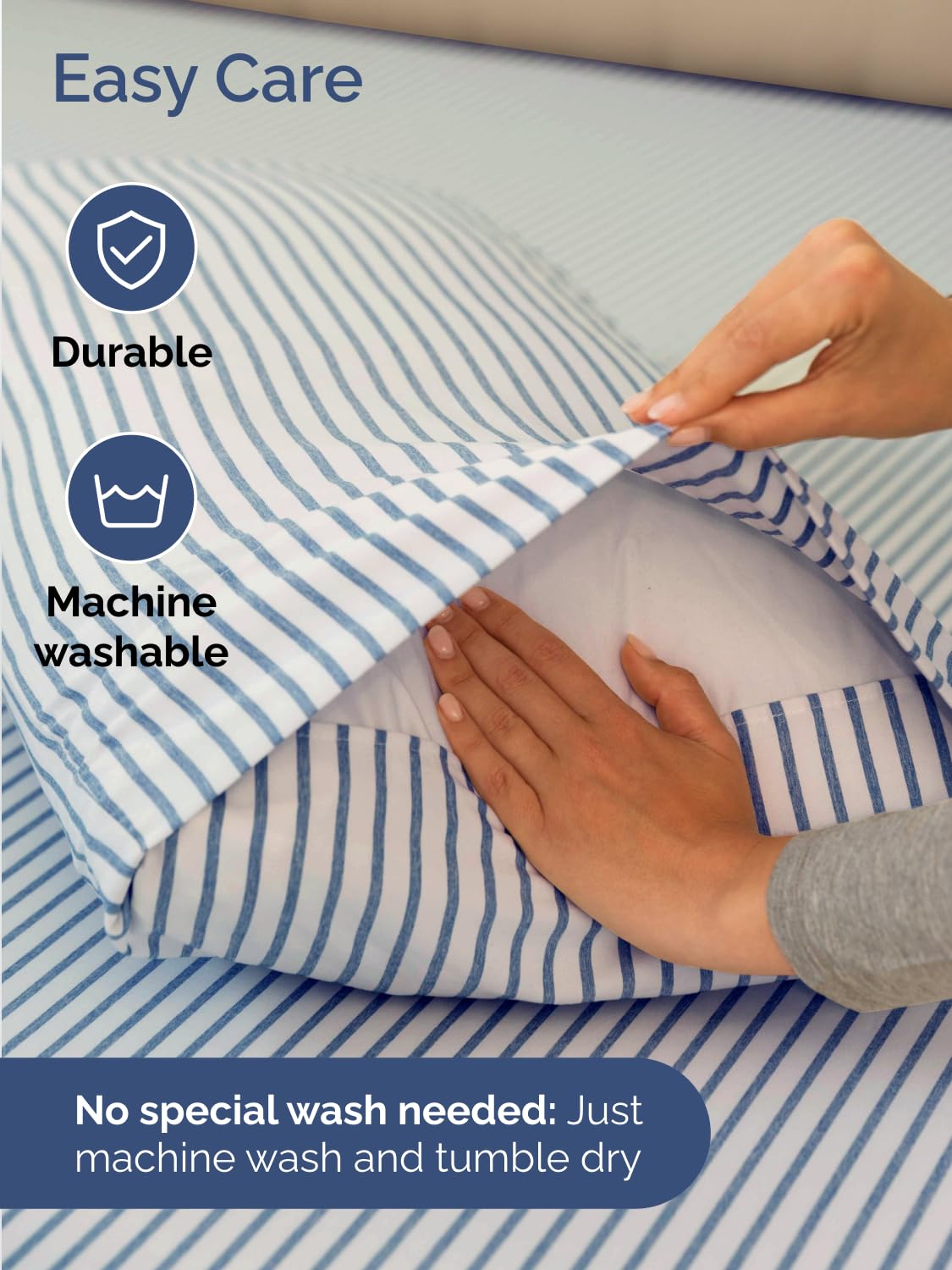 Blue striped CGK Unlimited king sheet set neatly made in a bedroom setup.