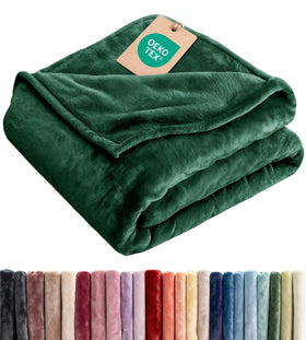 CGK Unlimited forest green ultra-soft fleece blanket on couch for cozy evenings