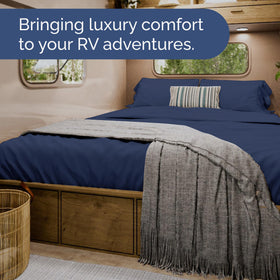 CGK Unlimited navy blue bedding on bed emphasizes premium hotel-like comfort.