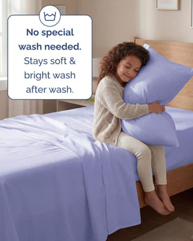 Lavender-toned bed scene highlights breathable, cooling feel for warm nights.