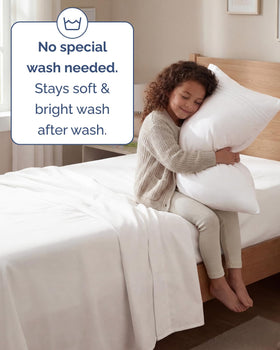 CGK Unlimited twin sheet set in a cozy bedroom scene suggests hotel-luxury comfort.