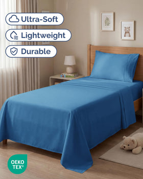 CGK Unlimited denim blue fitted sheet close-up highlights deep-pocket fit for thick mattresses.