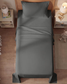 CGK Unlimited wrinkle-free finish on charcoal sheets under soft lighting