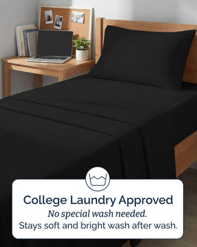 CGK Unlimited black sheet set with wrinkle-free finish on a bed
