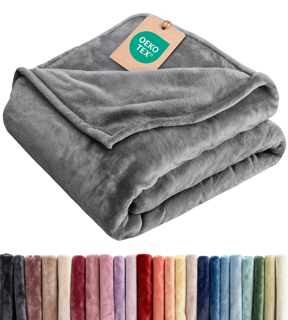CGK Unlimited ultra-soft fleece blanket on a couch for cozy lounging.