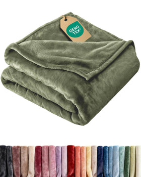 CGK Unlimited ultra-soft fleece blanket in olive on a bed for luxurious comfort