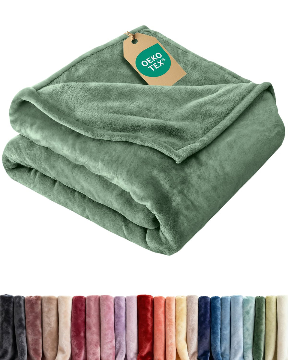CGK Unlimited ultra-soft fleece blanket twin on sofa for all-season coziness.