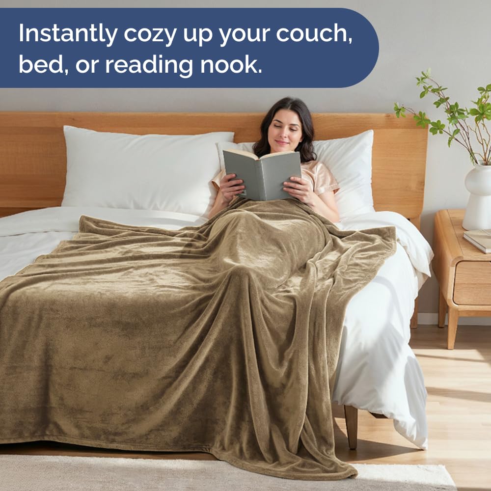 CGK Unlimited versatile blanket shown on bed and couch for travel and dorm use