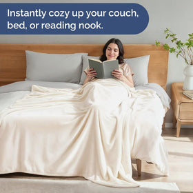 CGK Unlimited versatile blanket shown on couch and bed for lounging