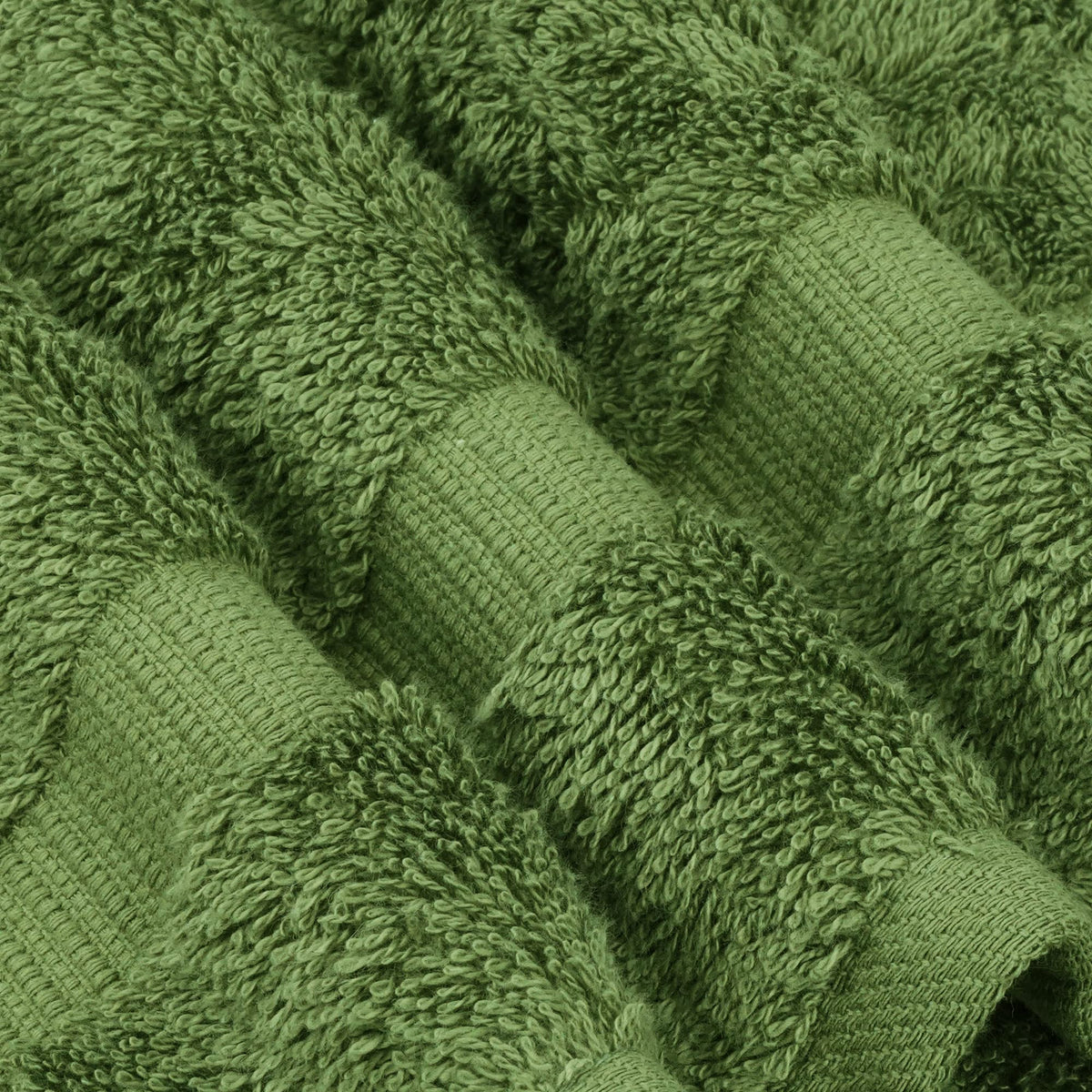 Chakir Turkish Linens moss hand towels in bathroom scene, showcasing natural weave and lasting strength.