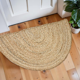 Chardin home hand-woven jute braided rug in half-round form adds rustic warmth.