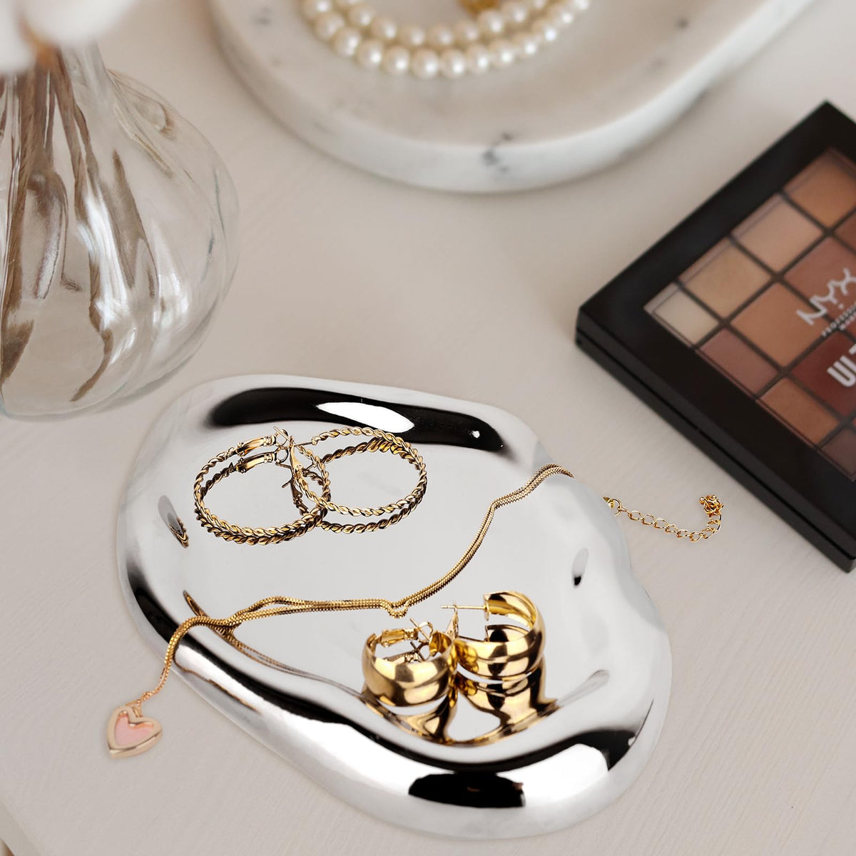 CHENDECOR silver tray dresser vanity display organizes cosmetics and keys.