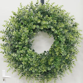 Chiyinbao boxwood wreath on window adds year-round charm.