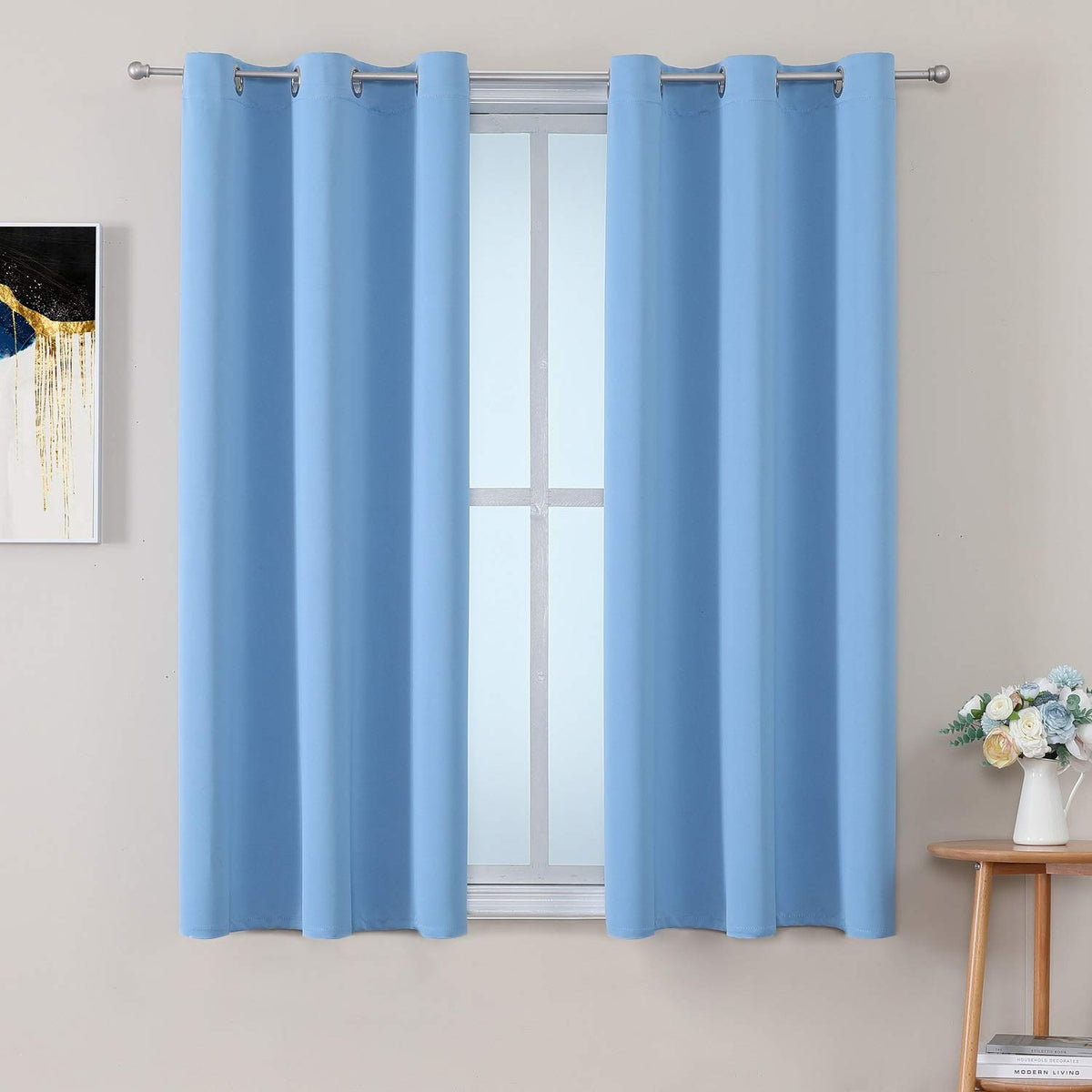 ChrisDowa grommet curtains sky blue panel blocks sunlight and adds soft texture.