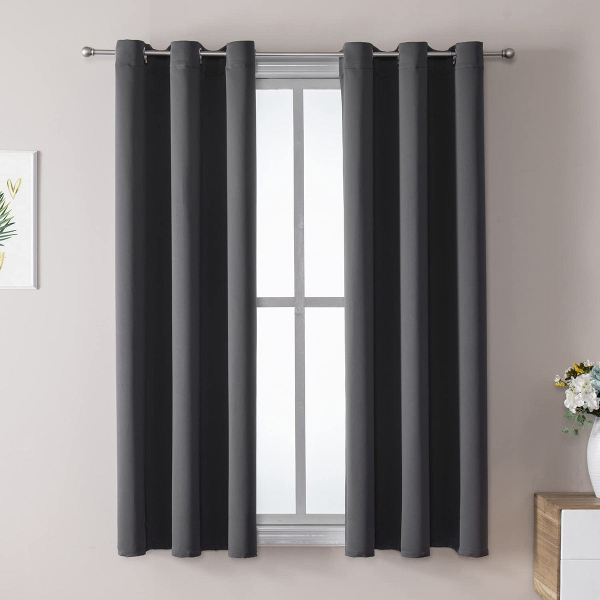 ChrisDowa grommet curtains with a two-panel set, blocking light for a darker bedroom.