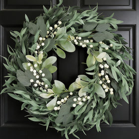 CIR OASES olive wreath on front door enhances year-round curb appeal.