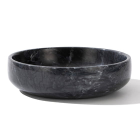 CM CHIC MONDAY 6.7-inch marble bowl sits on a coffee table with elegant storage.