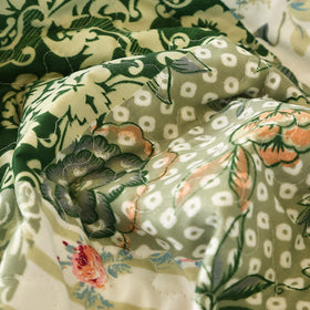 Stitching detail highlight on green and white floral pattern.