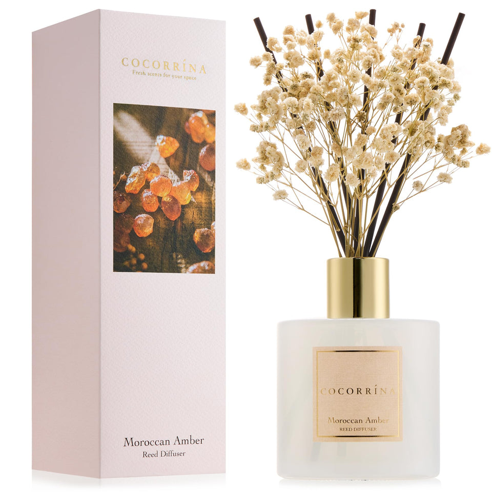 COCORRÍNA Moroccan Amber reed diffuser bottle adds refined ambiance to a living room.