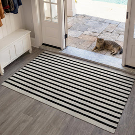 Reversible striped rug provides two looks for seasonal refresh on porch or kitchen.
