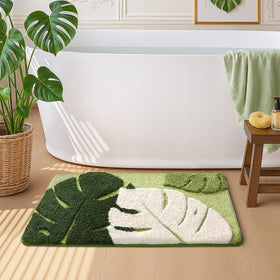 Color&Geometry absorbent green bath mat keeps floors dry after showers.