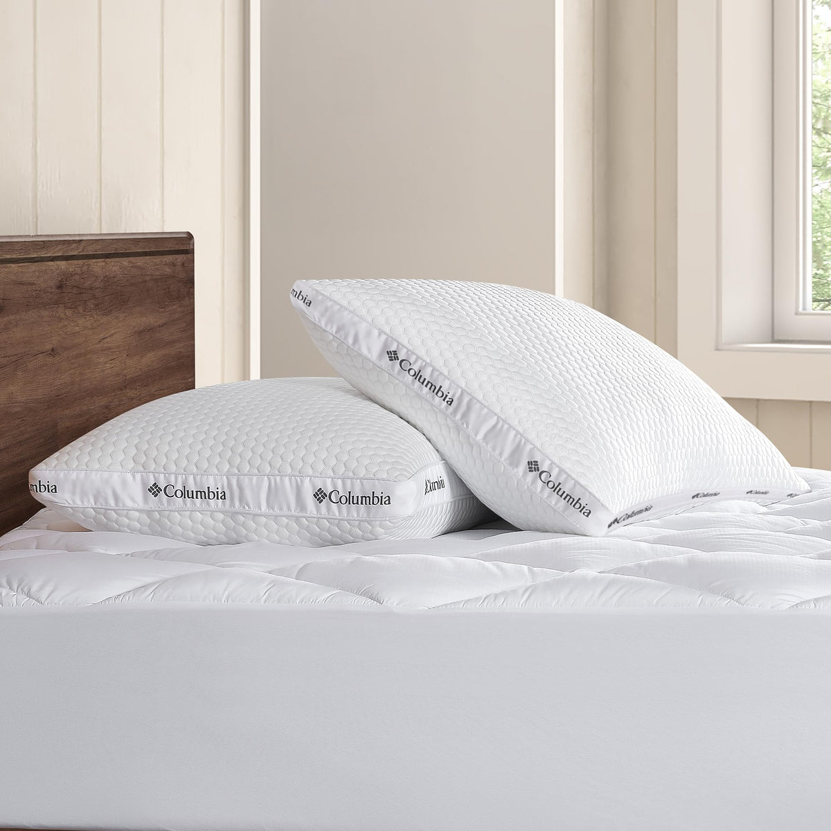 Columbia Ice Fiber pillow on bed with case demonstrating standard/queen size fit.