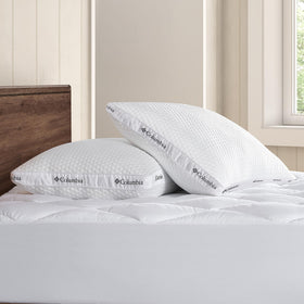 Columbia Ice Fiber pillow on bed with case demonstrating standard/queen size fit.
