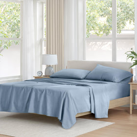 Comfort Spaces full-blue cotton sheet set laid flat, showing the crisp flat sheet and fabric texture.