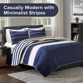 Verone sham with khaki stripes on navy ground enhances bed styling.