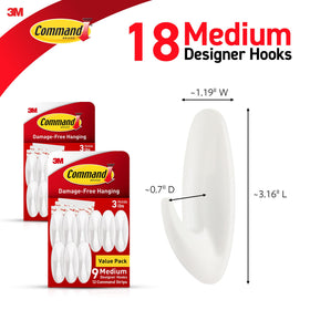 Closeup of Command Designer Hooks with adhesive strips for damage-free hanging.