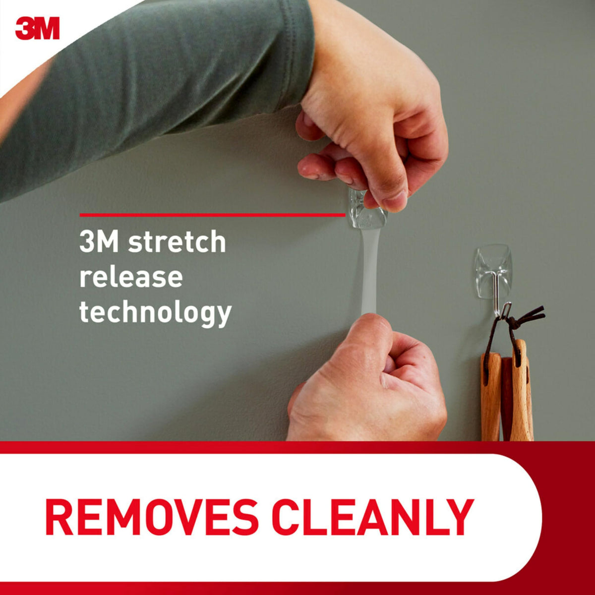 Hook attached to glass surface by Command shows versatile mounting capability.