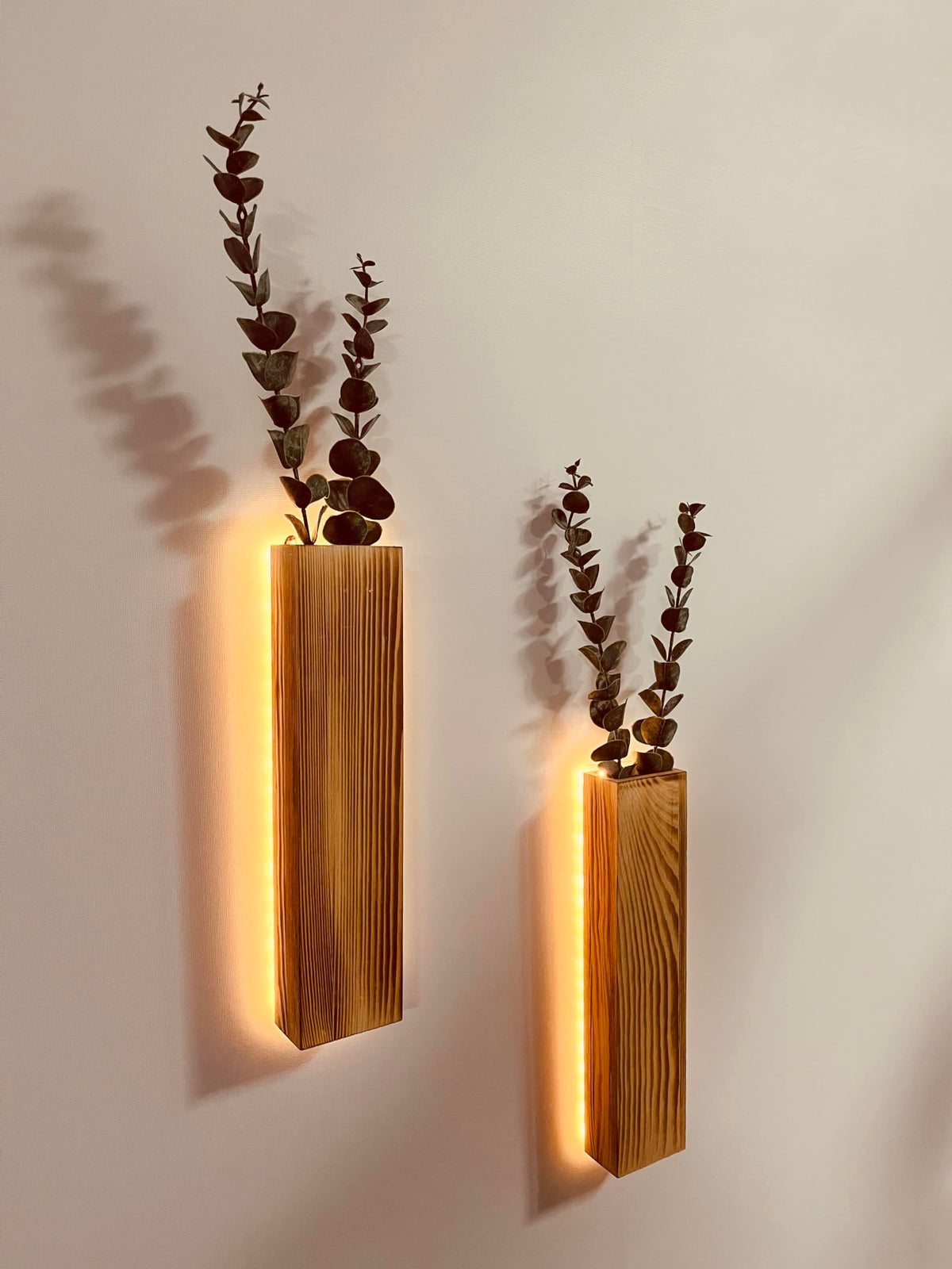 Comtelek artificial eucalyptus LED wall planter set adds warm ambient light to an entryway