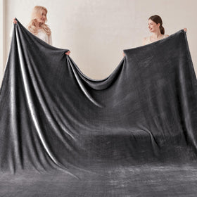 COOVA blanket on a sofa illustrating versatile lounging warmth.