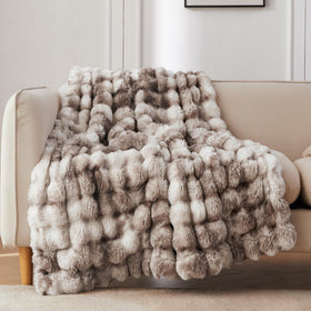 COOVA faux fur throw with bubble pattern adds cozy texture to sofa.