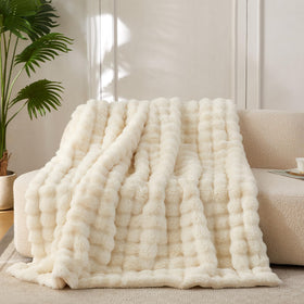 COOVA faux fur throw blanket with bubble texture for luxurious warmth.