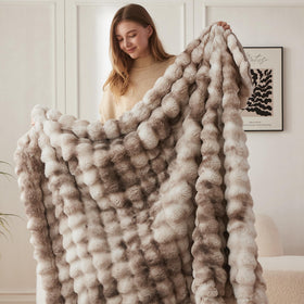 COOVA faux fur throw folded on a sofa shows plush fullness