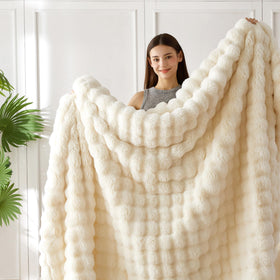 COOVA ivory white faux fur throw in a bedroom creating inviting ambiance.