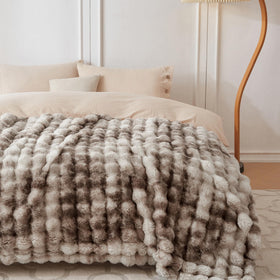 COOVA plush rabbit fur throw shows bubble texture for luxurious warmth.