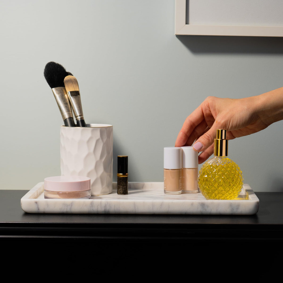 Cork & Mill marble tray in a large vanity setup with skincare and fragrances.
